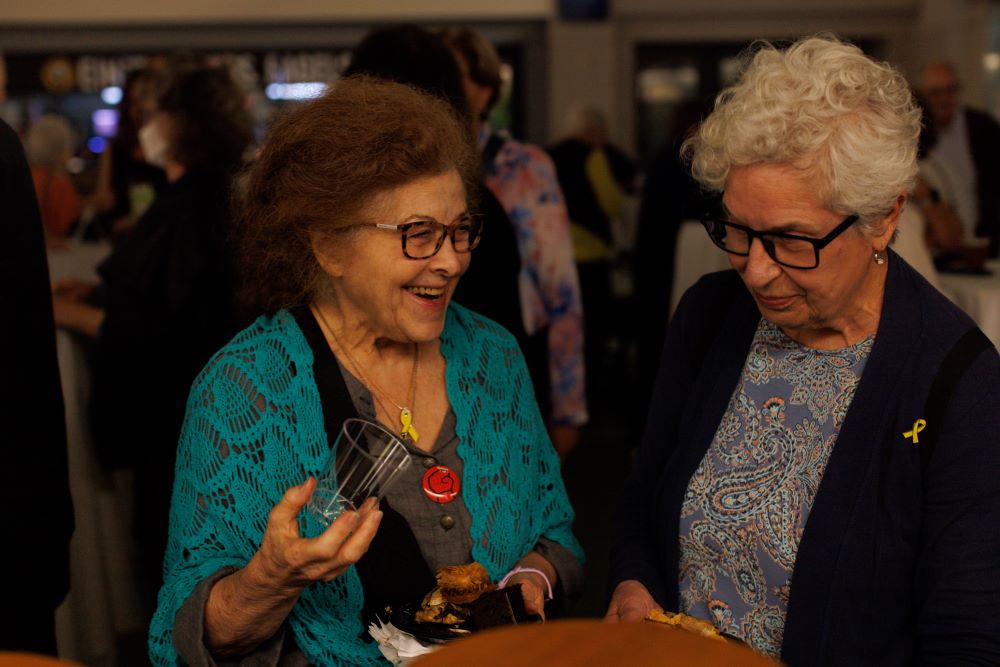 Two attendees share a smile during the reception.
